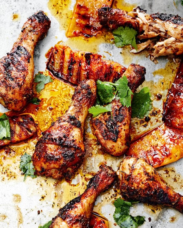 Cajun chicken drumsticks with charred pineapple wedges 