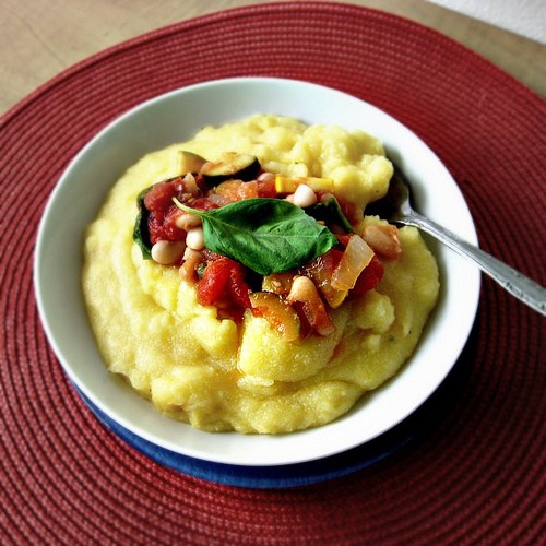 Cannellini beans with fresh basil, tomatoes, capers and zucchini over polenta