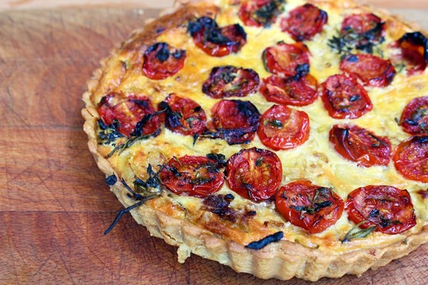 Caramelised onion, polenta and oven-roasted tomato tart