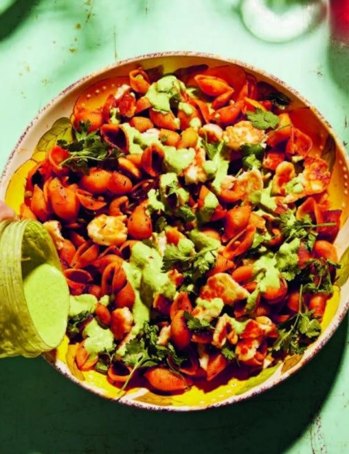 Caramelised shells with halloumi, spiced tomato dressing, fried cashews & pea raita