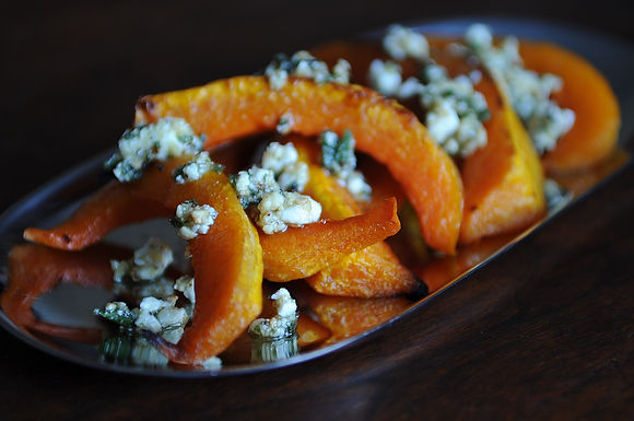 Caramelized butternut squash wedges with a sage hazelnut pesto