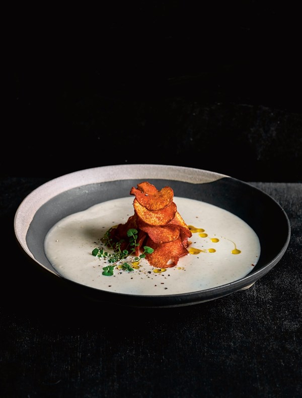 Caramelized garlic, German butter potato & pine nut soup, Aleppo pepper powder potato chips, smoked sunflower oil