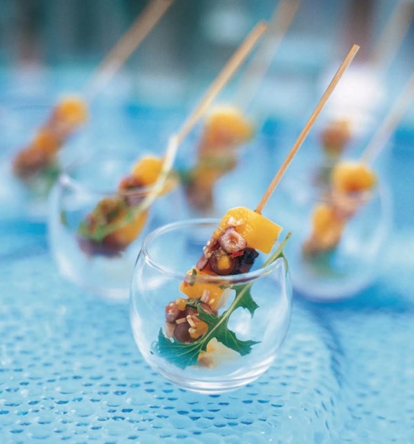 Caramelized green mango and octopus skewers