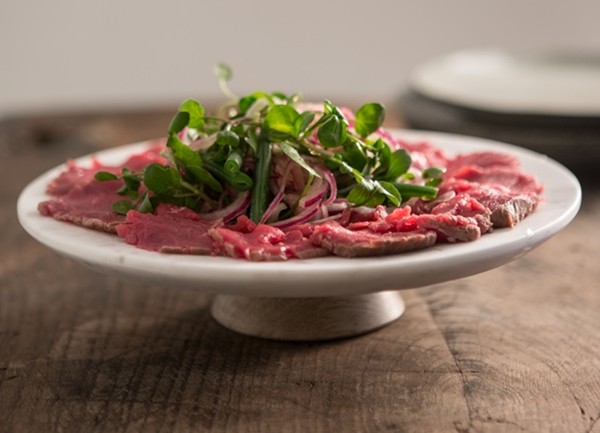 Carpaccio of beef with a sweet and sour onion and green bean salad