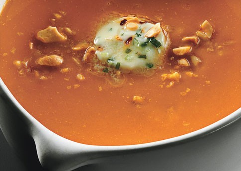 Carrot-ginger soup with chile butter and roasted peanuts