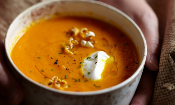 Carrot soup with chives and popcorn