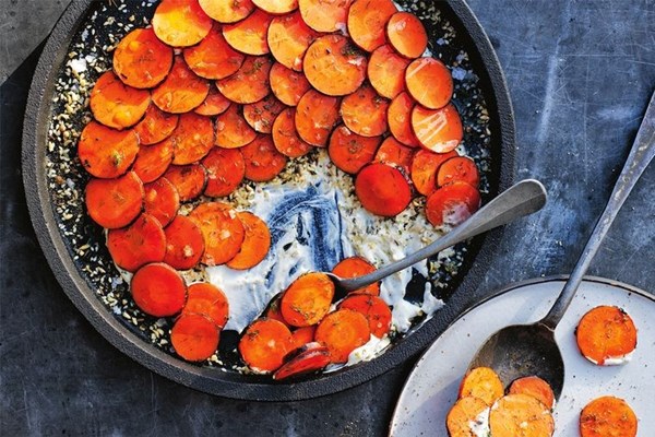 Carrots cooked over coals, labneh and toasted seeds