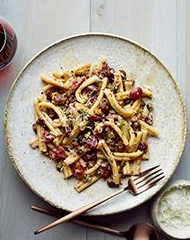 Casarecce with sausage, pickled cherries and pistachios