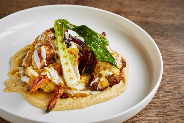 Cashew nut hummus with roasted vegetables, a light curry dressing, nut milk and lime