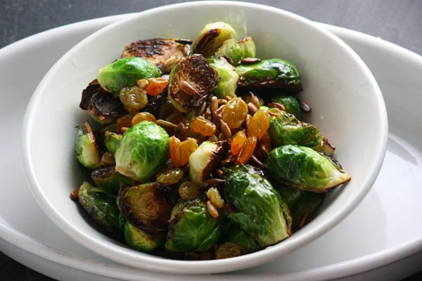 Cast-iron pan-fried Brussels sprouts with pickled raisins and sunflower seeds