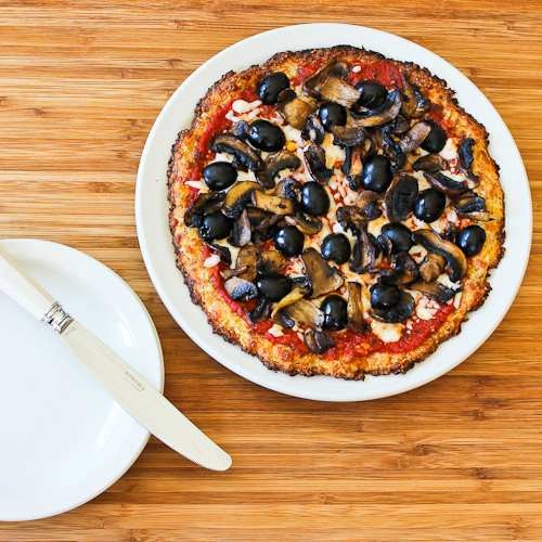 Cauliflower-crust vegetarian pizza with mushrooms and olives (cooked on the grill or in the oven)