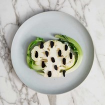 Cauliflower hearts, florets and leaves with black garlic