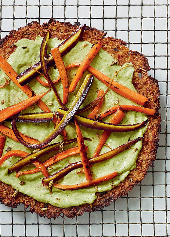Cauliflower pizza crust with carrot-top pesto and rainbow carrots