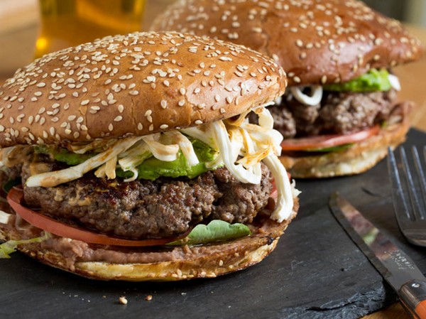 Cemita burger with refried beans, chipotle mayo, avocado, and Oaxacan cheese