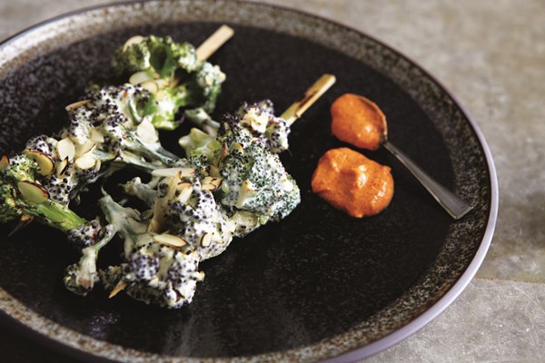 Char-grilled broccoli florets with rose petals and almonds