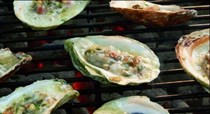 Char-grilled oysters with bacon-bourbon-ginger butter