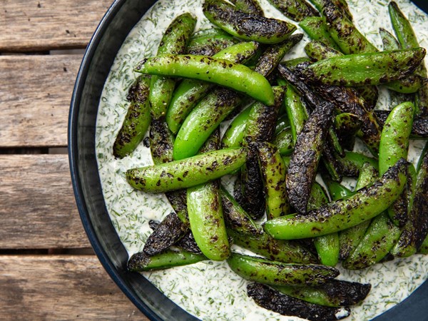 Charcoal chimney–grilled sugar snap peas with buttermilk-dill dressing 