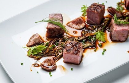 Chargrilled Gressingham duck breast with spring onion, pickled shiitake mushrooms, garden herbs and soy reduction