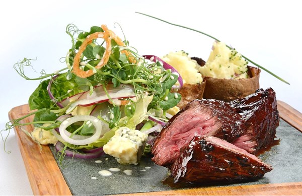 Chargrilled hanger steak with loaded potato skins [Lisa Goodwin-Allen]