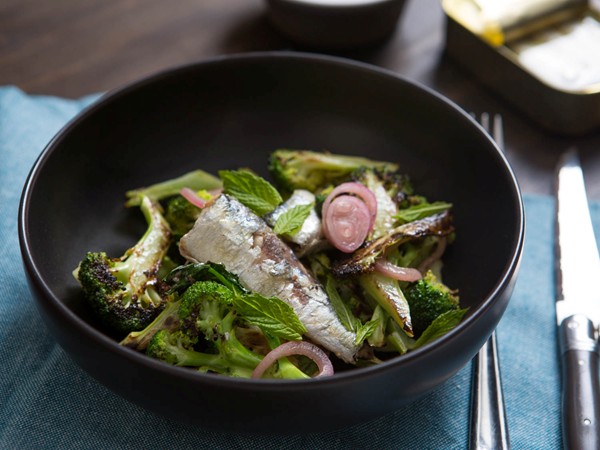 Charred broccoli salad with sardines, pickled shallot, and mint