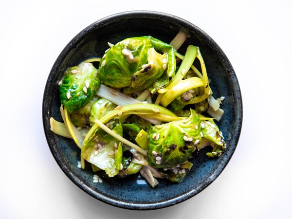 Charred Brussels sprouts and leek muchim with coffee-Dijon dressing