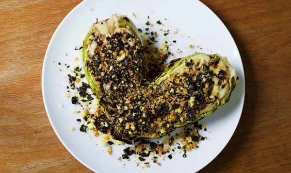Charred hispi cabbage topped with crushed Scampi Fries and Frazzles