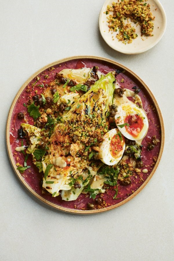 Charred hispi cabbage with anchovy sauce, soft eggs, crispy capers and pangrattato
