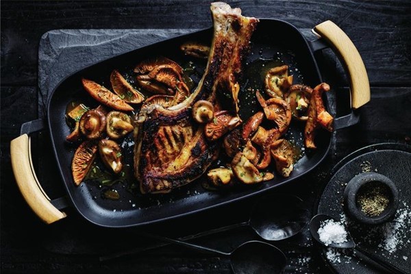 Charred pork tomahawk with mushroom sauce
