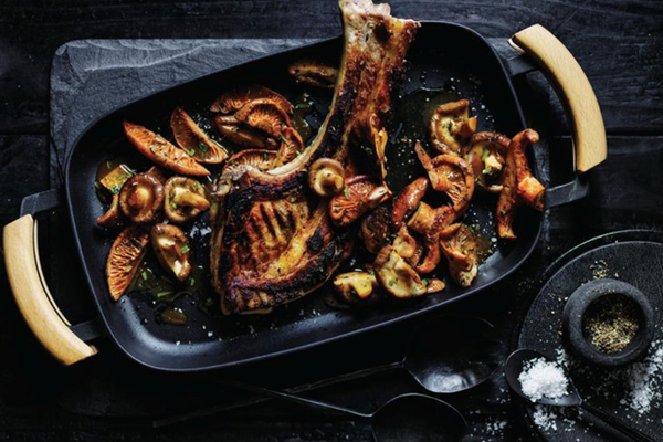 Charred pork tomahawk with mushroom sauce