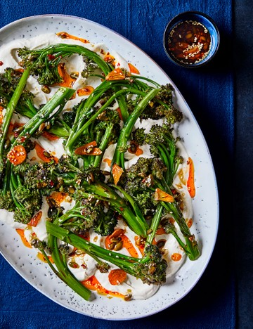 Charred purple sprouting broccoli with tahini yogurt and spiced seeds