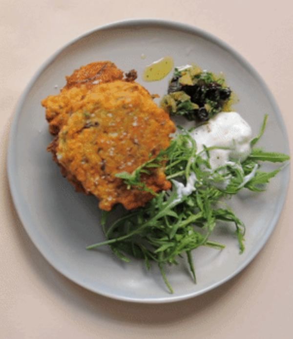 Charred spring onion and pea fritters with a yoghurt and herb salad 
