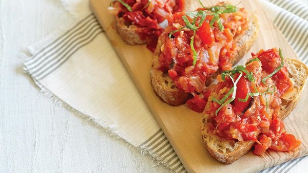 Charred tomato, pepper, and onion crostini