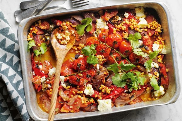 Charred tomatoes and onions with feta-harissa pine nuts