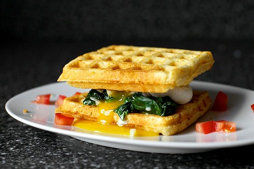 Cheddar cornbread waffle sandwich with creamed greens and poached egg