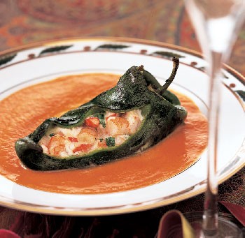 Cheese- and shrimp-stuffed roasted poblanos with red bell pepper sauce