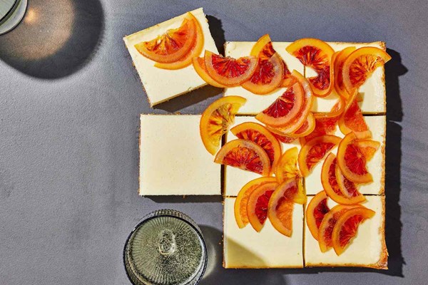 Cheesecake bars with candied orange and pizzelle crust