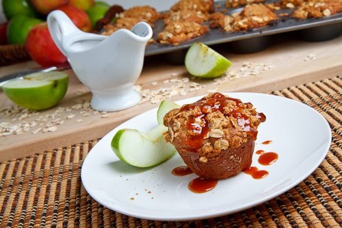 Cheesecake stuffed apple muffins with streusel topping and caramel sauce
