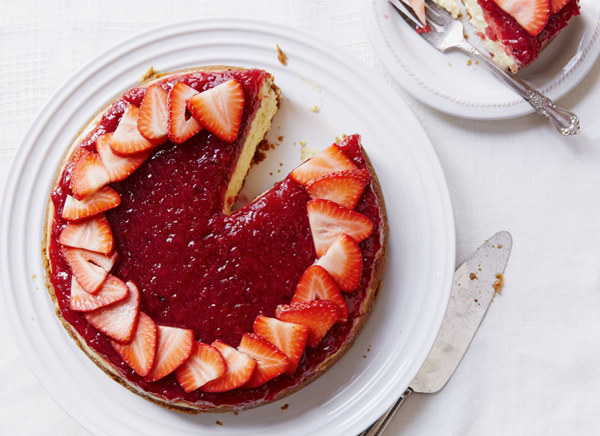 Cheesecake with charred rhubarb compote and sliced strawberries