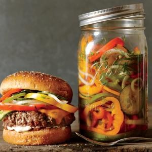 Cheesesteak burgers with pickled peppers, onions, and cucumber