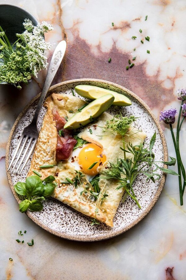 Cheesy baked egg crepes with spring herbs and avocado