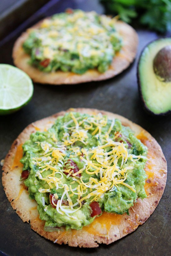 Cheesy guacamole tostadas