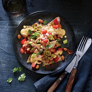 Cheesy nachos with pinto bean salsa and pickled jalapeños