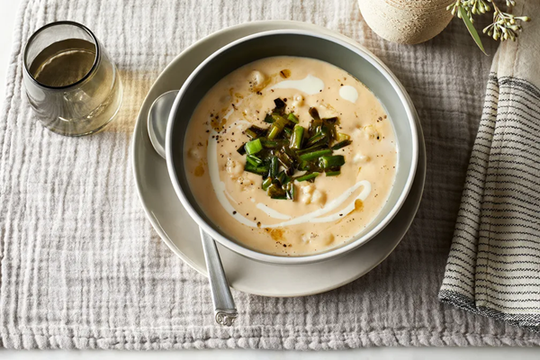 Cheesy potato soup with peppered scallions
