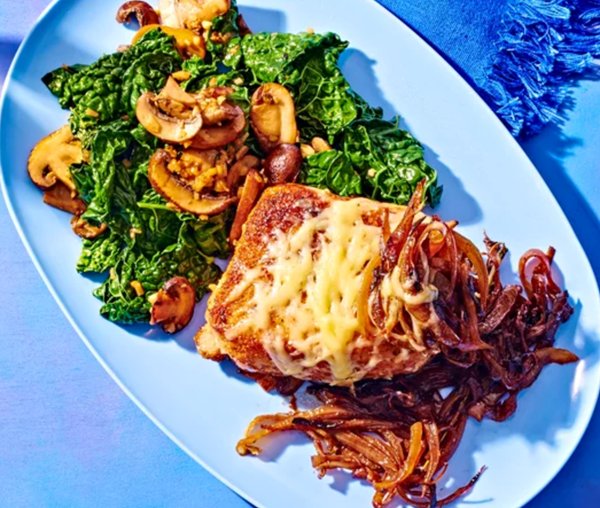 Cheesy smothered pork chops with garlicky mushrooms & kale