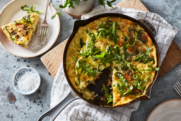 Cheesy spinach & artichoke frittata with arugula