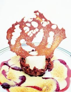 Chèvre cheesecake in a cocoa-nib florentina cup with Port-poached pears