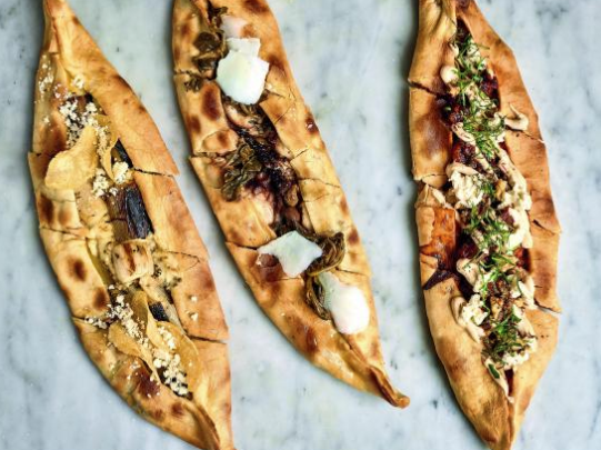 Chicken & garlic köfte pide with chili yogurt, smoked salsa, walnuts & feta