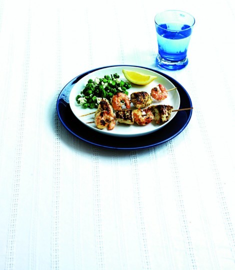 Chicken and prawn skewers on summer Greek salad