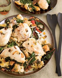 Chicken baked on a bed of bread and Swiss chard