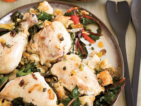 Chicken baked on a bed of bread and Swiss chard